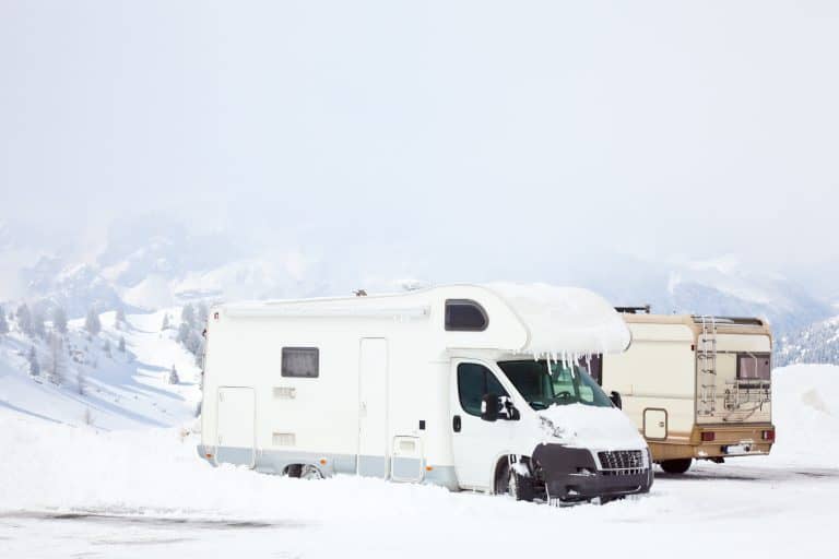 Class B motorhome covered with snow and ice.