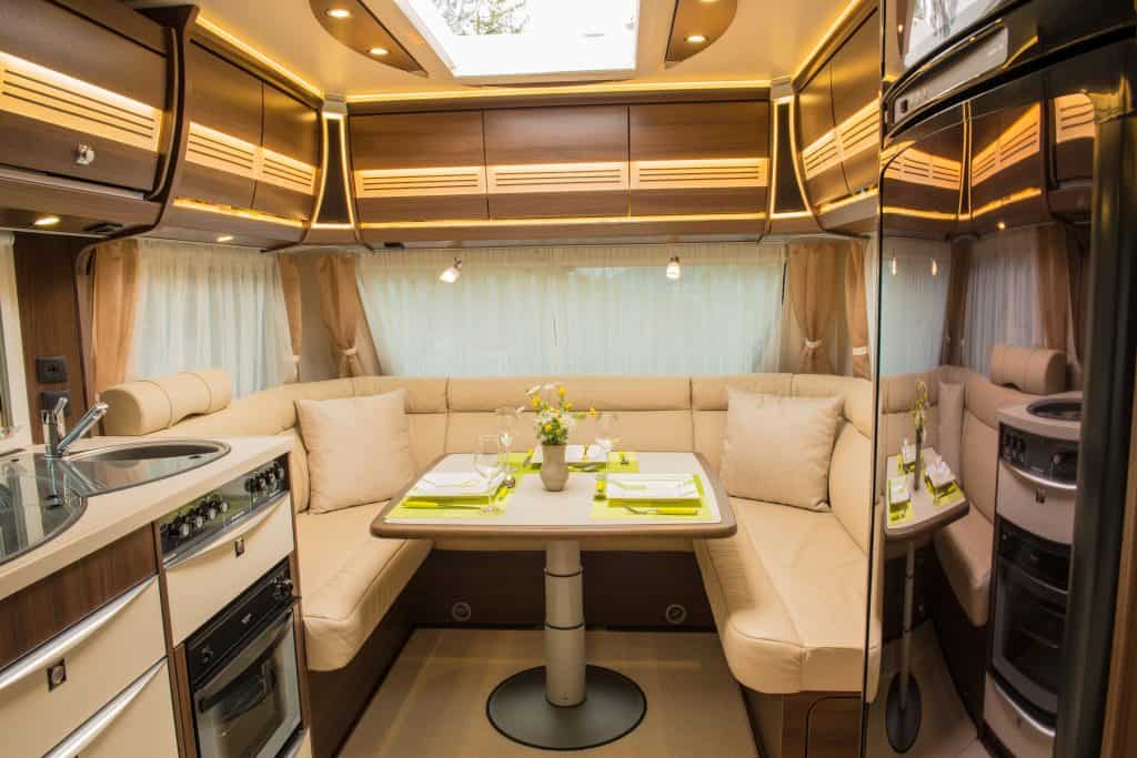 Dining area of a travel trailer with lots of windows