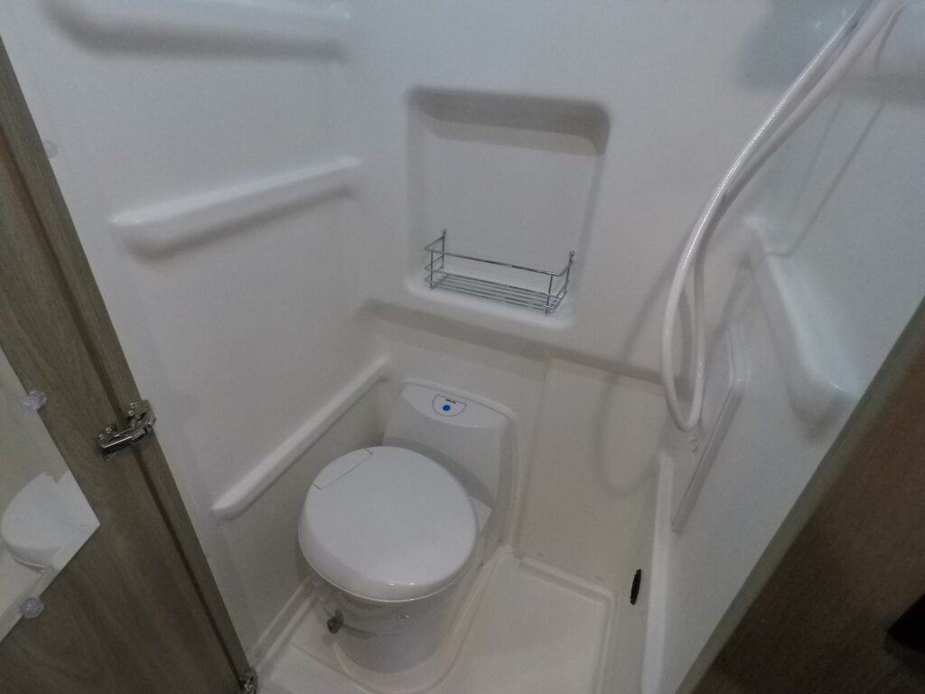 Class B RV bathroom with toilet and shower.