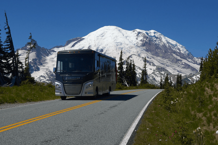 Class A motorhome driving on mountain highway.