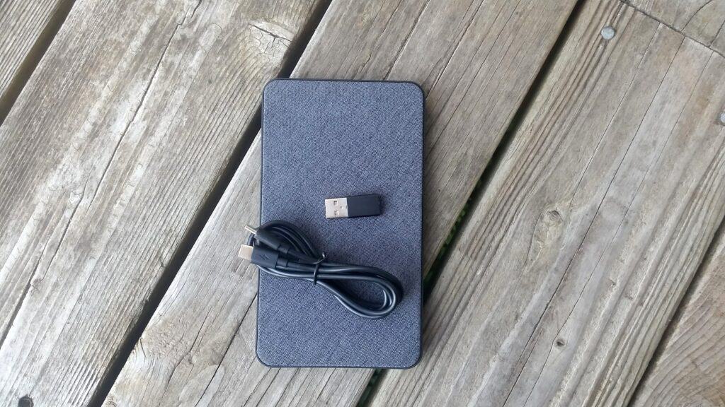 A portable power bank with cord and usb adapter.