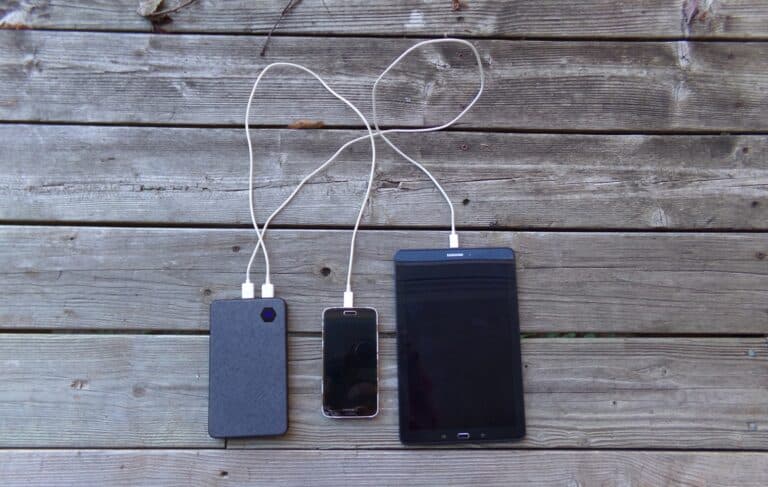 Mobile devices plugged into chargers.