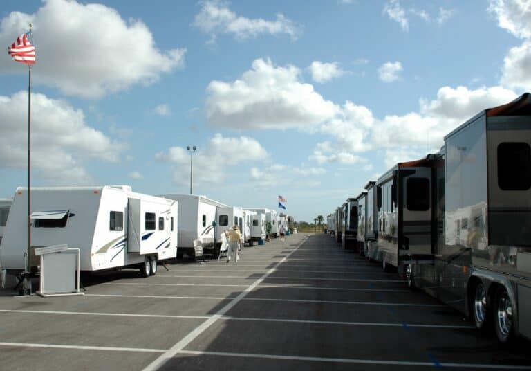 Motorhomes and travel trailers on a delear lot.