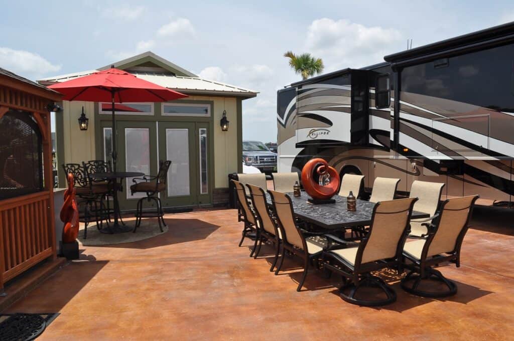 Table, casita, and motorhome at a Luxury RV site at Bella Terra Resort.