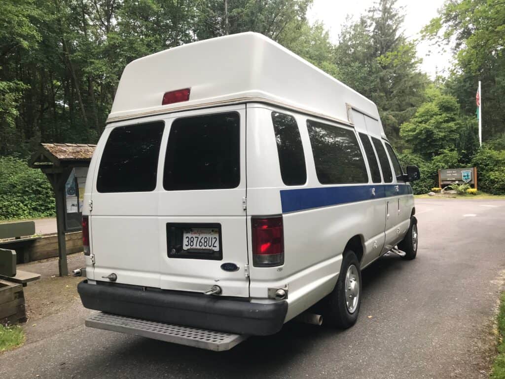 A white conversion van becomes a camper van or Calls B Rv