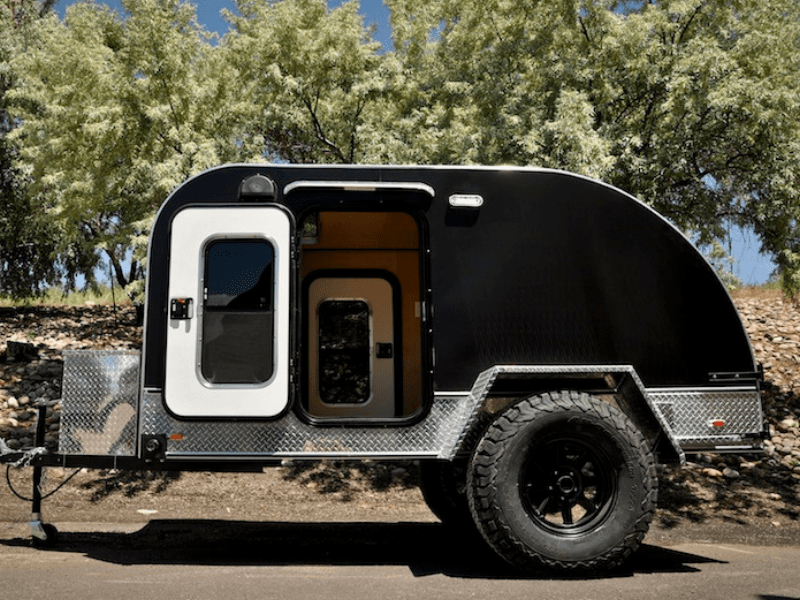Colorado Teardrops camper parked with door open.