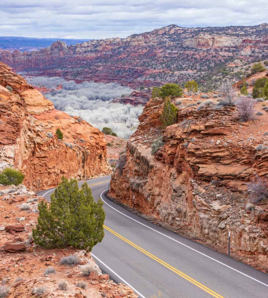Scenic highway through red canyons with no vehicles.