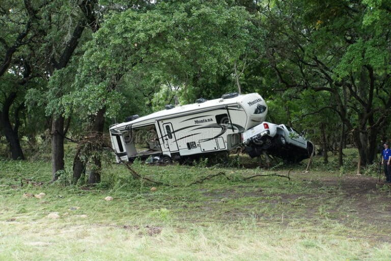 Wrecked truck and trailer in the brush due to a flash flood,