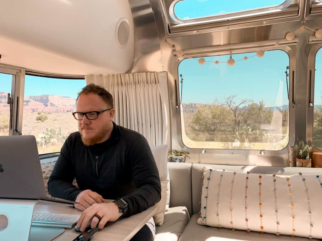 Man working in Airstream trailer - jobs for full-time RVers