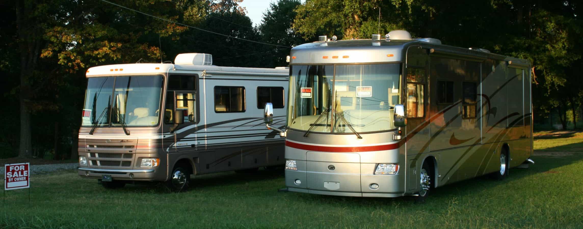 two motorhomes in yard listed for sale