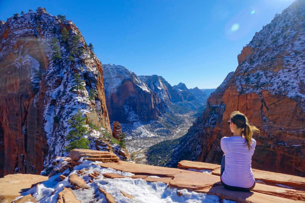 Woman sitting overlooking Zion National Park in Utah