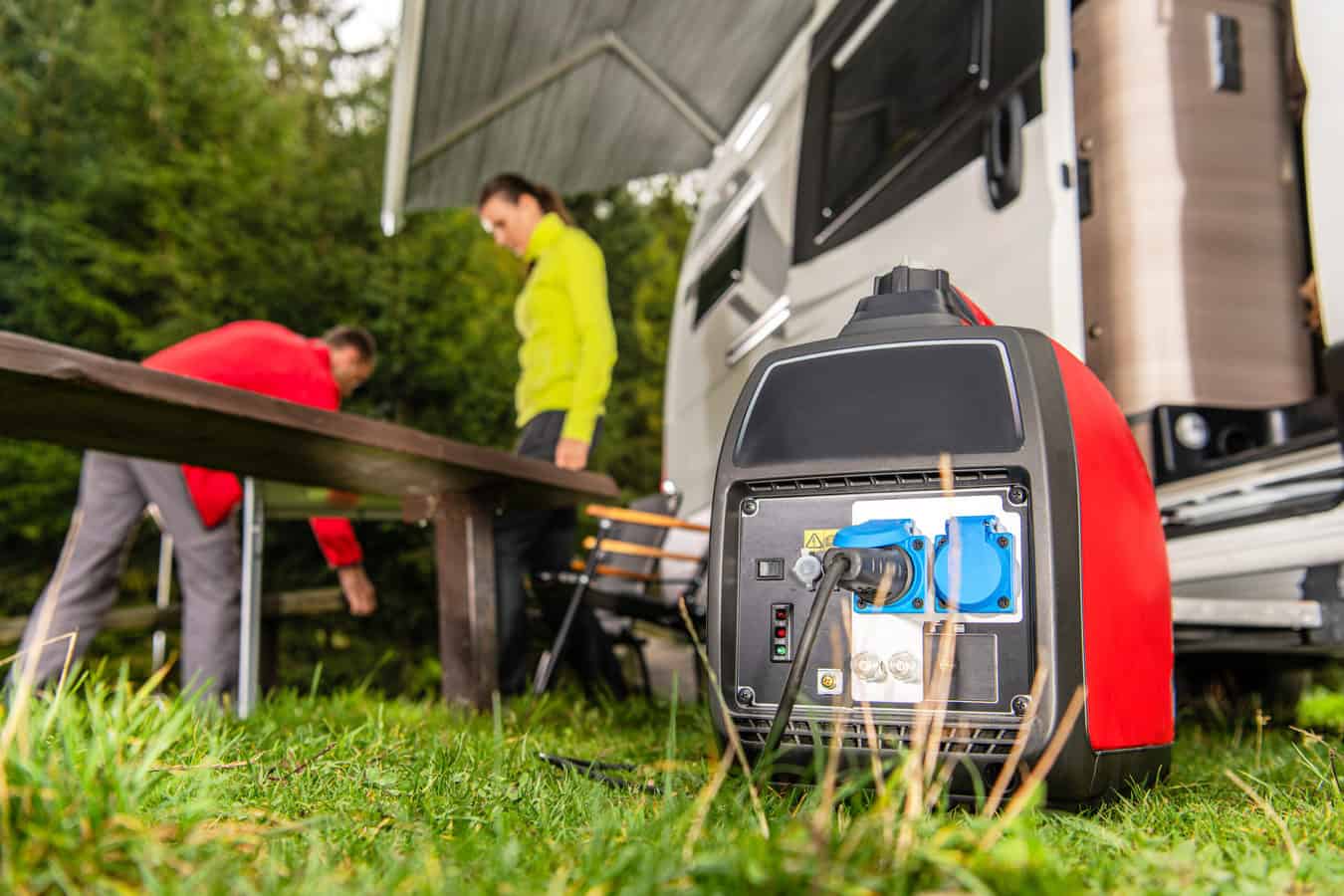 Man and woman at campsite with generator in the foreground - quiet generator for RV