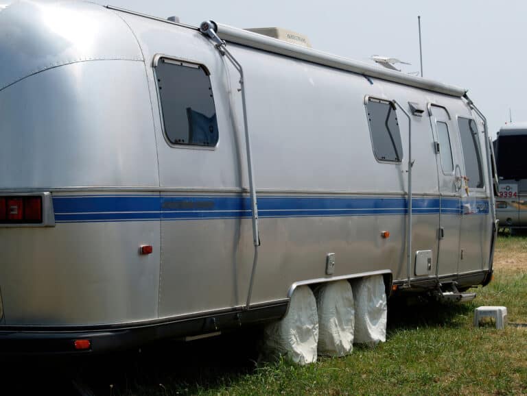 Airstream parked with camper tire covers