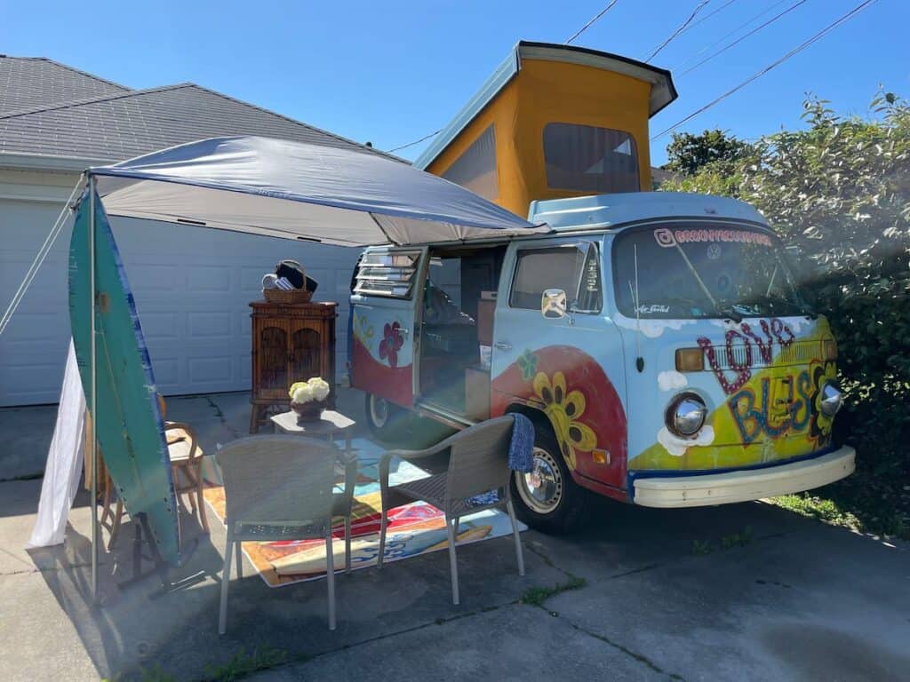 1970's themed Volkswagon Westfalia van parked in a driveway - RV Airbnb
