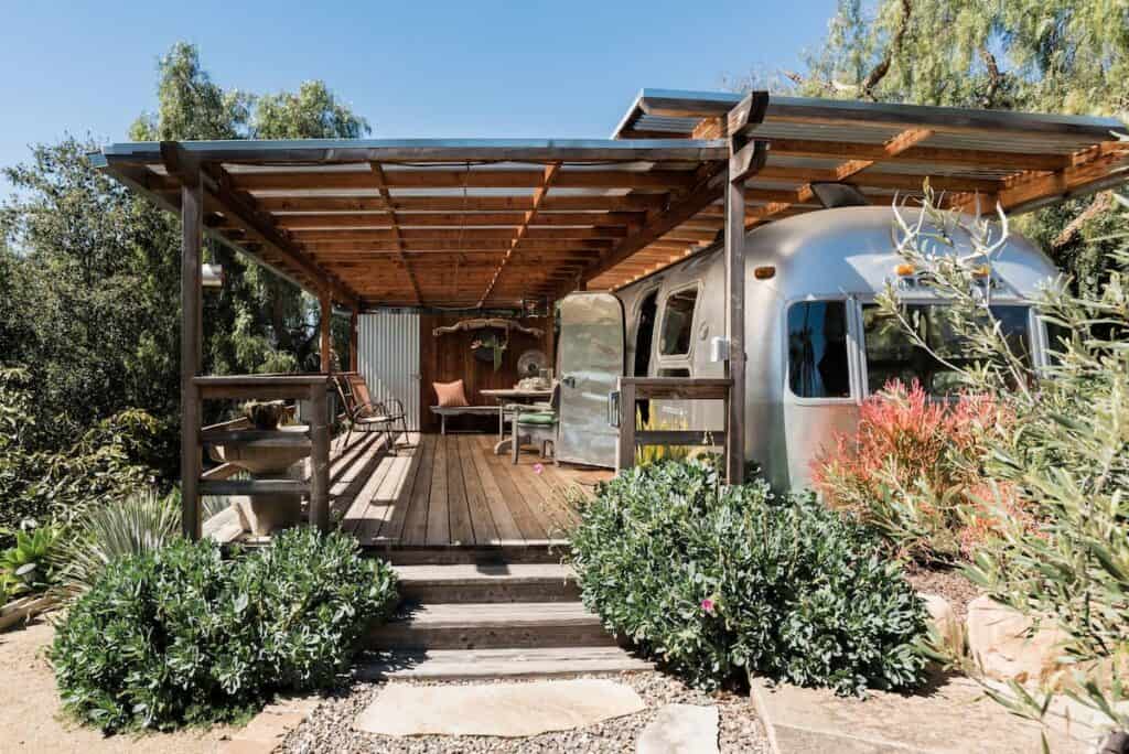 Airstream RV Airbnb with covered patio surrounded by plants