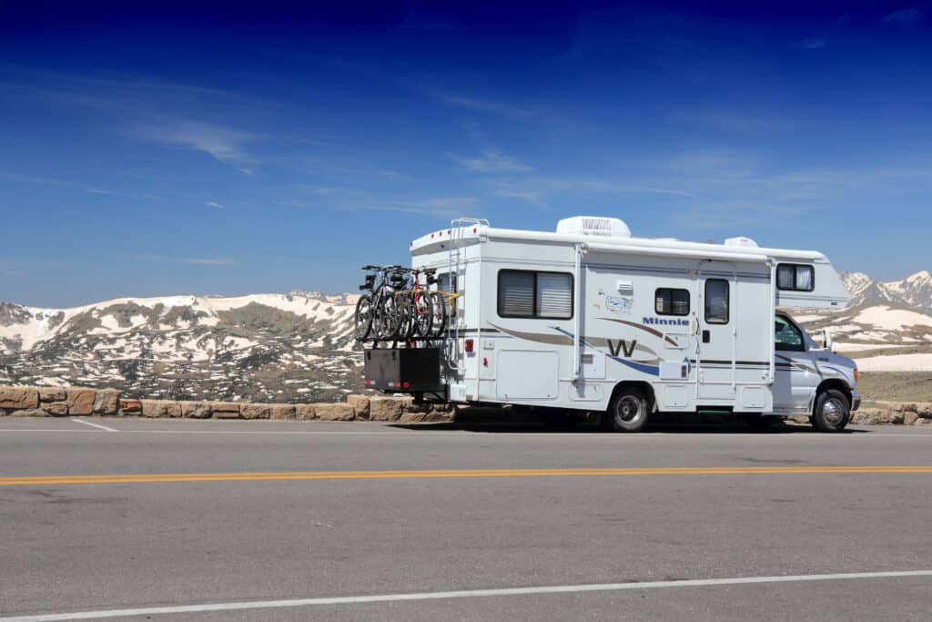 Class C RV in front of Rocky Mountains - cover photo for The Pitfalls Of Renting Out Your RV
