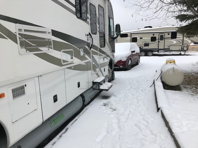 Airskirts mounted under a class A motorhome in the snow.