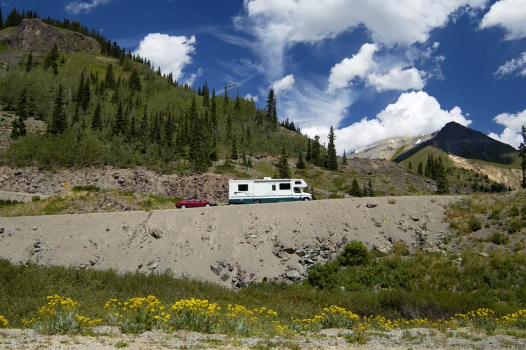 Class C RV towing a car in Colorado - Feature photo for Can A Class C RV Tow A Car?