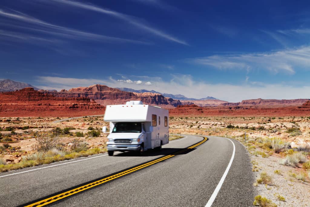 Class C RV on road in Utah - feature photo for How To Get The Best Deal On An RV