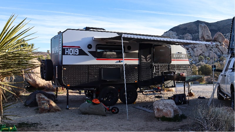 Black Series trailer set up in rugged, rocky seeting - Black Series campers