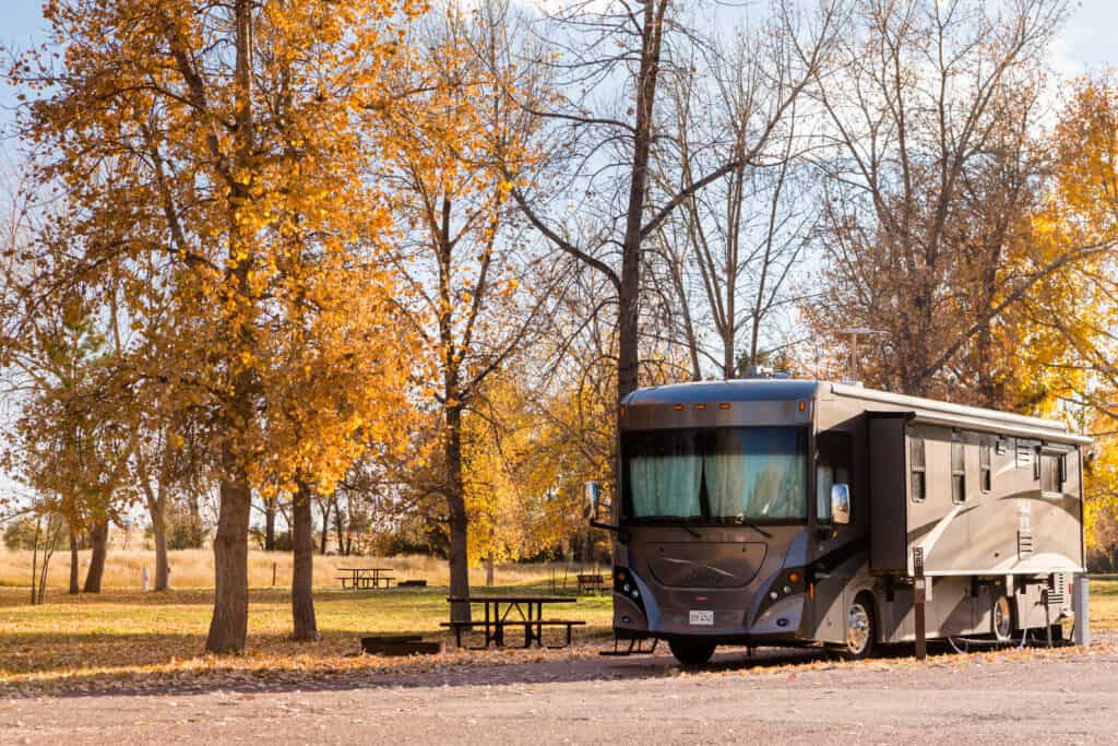 luxury motorhome rental at campsite with autumn view