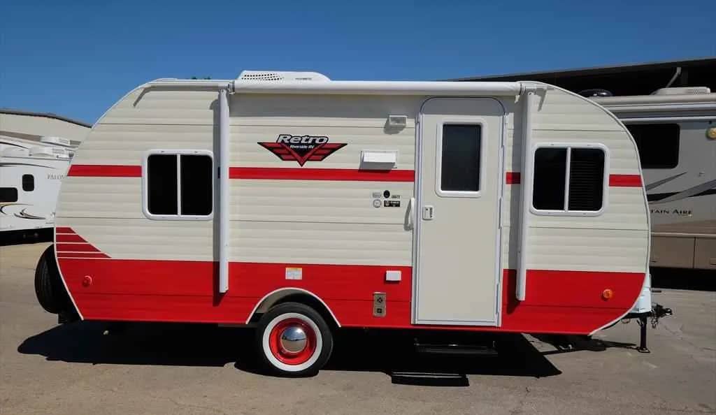 this red and white retro travel trailer in a dealer lot might cause you to ask yourself, how much is my rv worth?