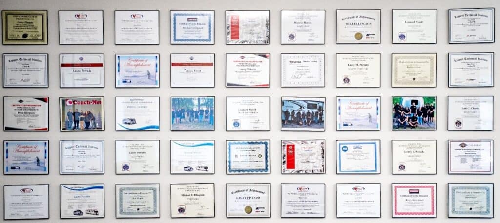 a wall full of framed rv technician certificates.