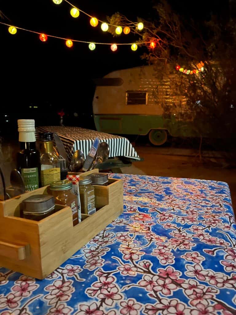 well adorned picnic tables in front of a classic Shasta RV