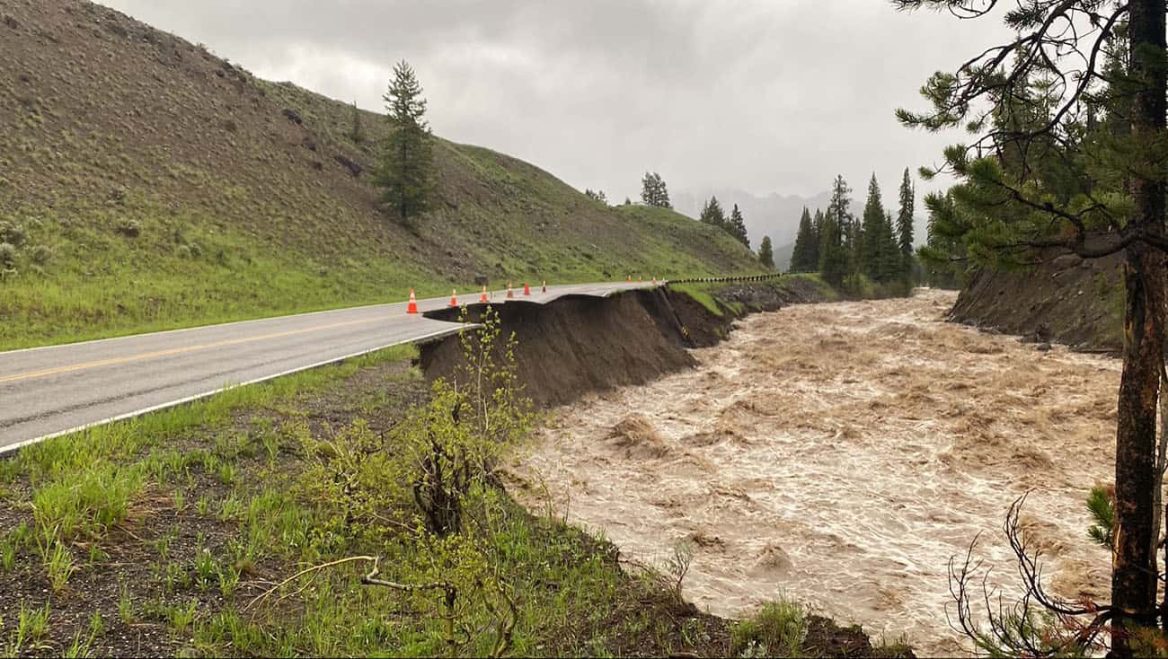 Half a road in Yellowstone that has collapsed into the river to to substantial flooding.