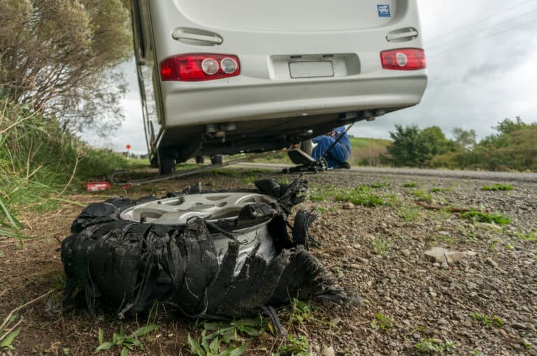 RV with tire on the side of the road - feature image for Goodyear RV tire recall