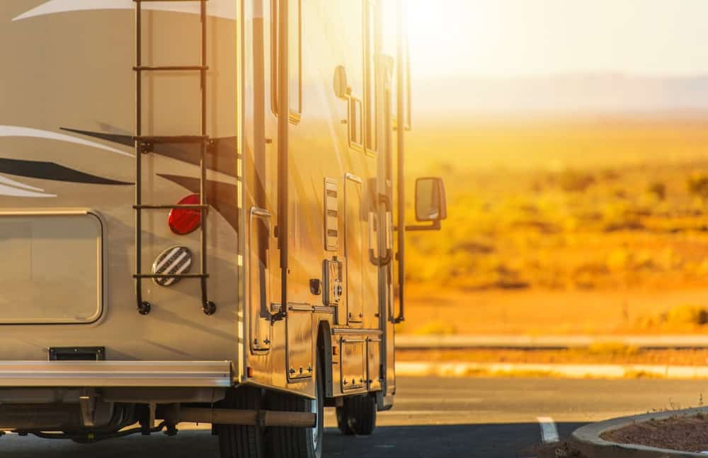 Class A Motorhome against a bright sunny desert background.