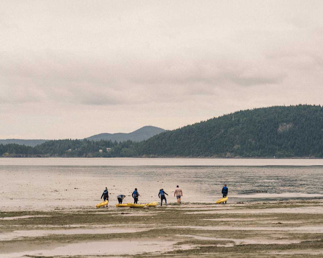 people kayaking at adult summer camp
