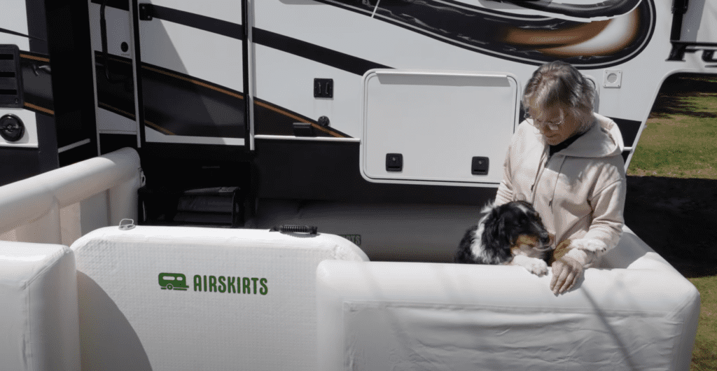 woman with dog inside a pet patio in front of an rv.