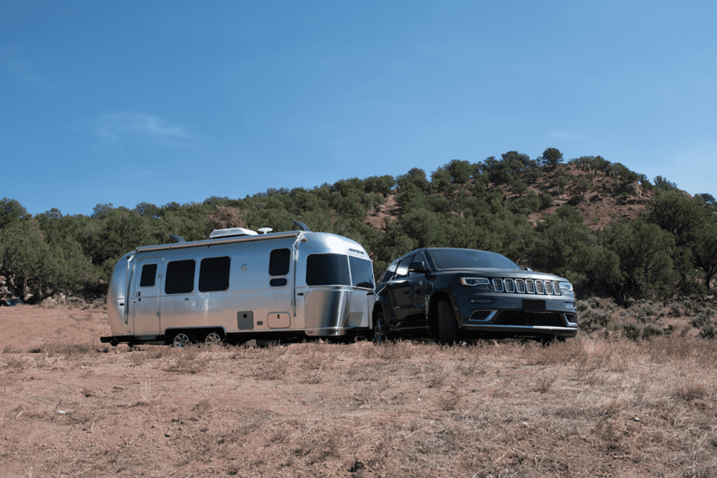 Airstream Flying Cloud 23FBbeing towed by an SUV in desert area