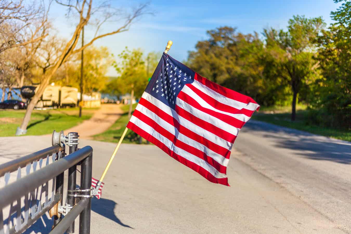 flag waving in front of campground - feature image for RV loans for veterans
