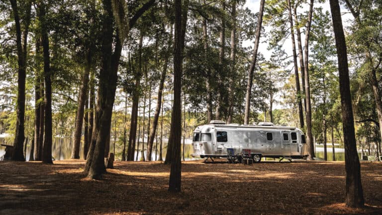 Airstream in woods - feature for Airstream travel trailers 2023