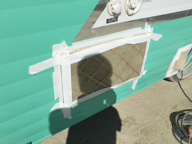 Classic travel trailer with vents covered to keep dust out during burning man.