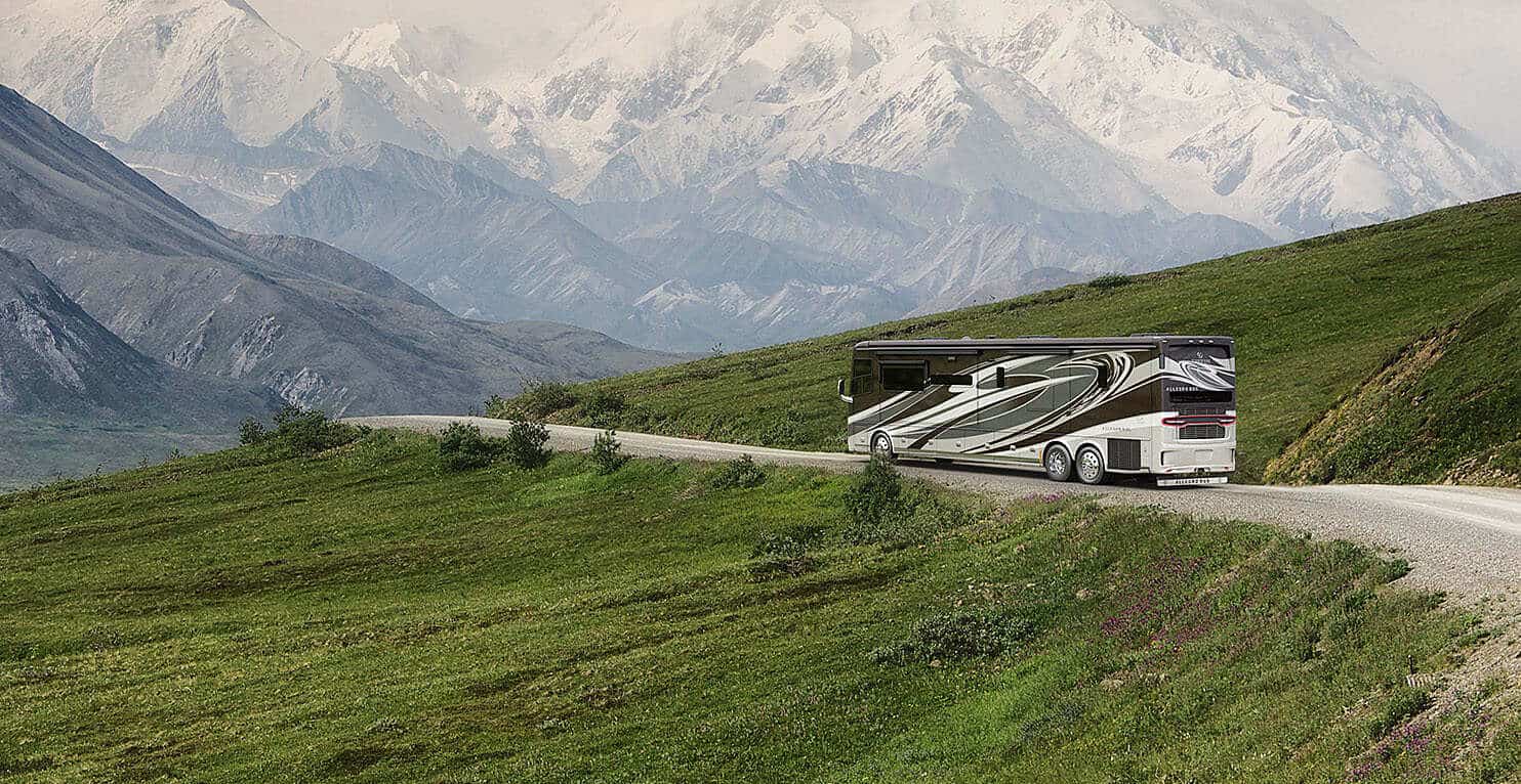 Tiffin Allegro Bus on road with mountain landscape