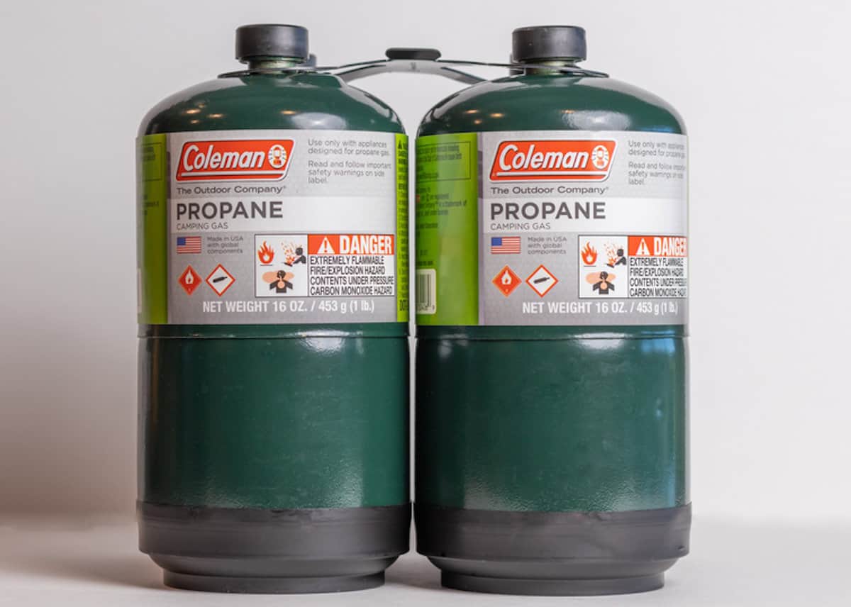 2 single use propane cylinders on gray background