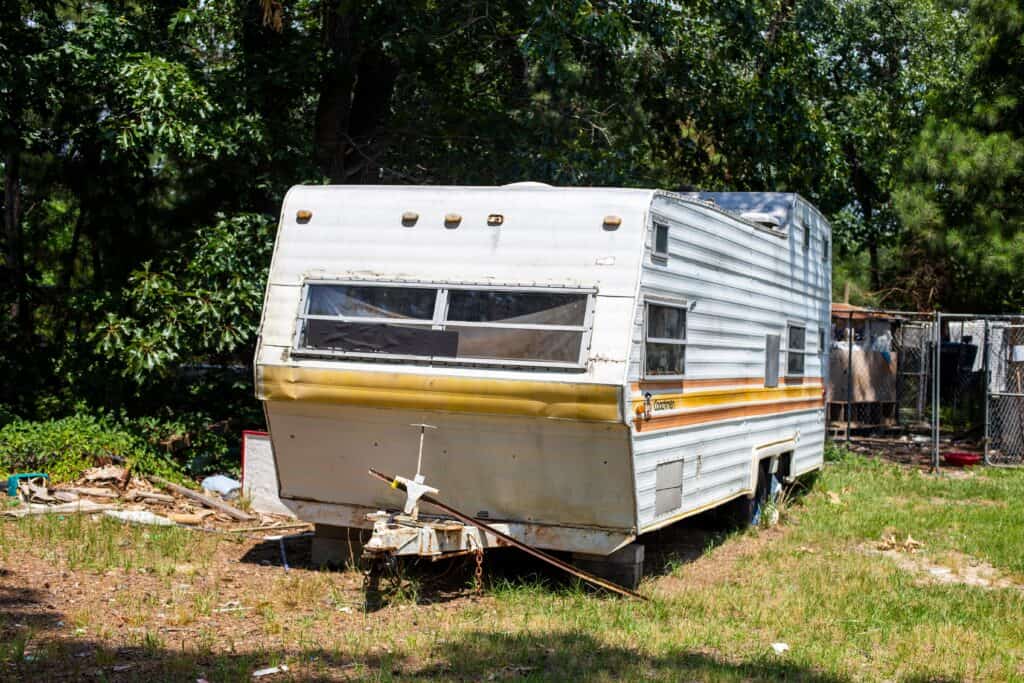 old RV in campsite - feature image for how do I get rid of an old RV