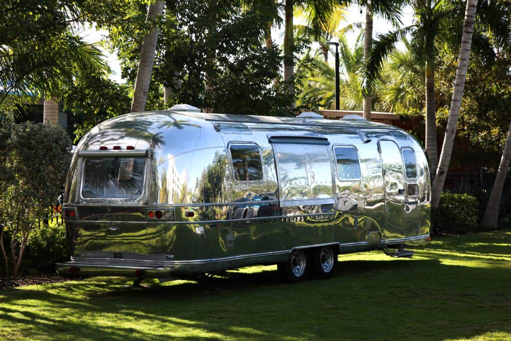 Polished Airstream parked amongst trees - Airstream alternative