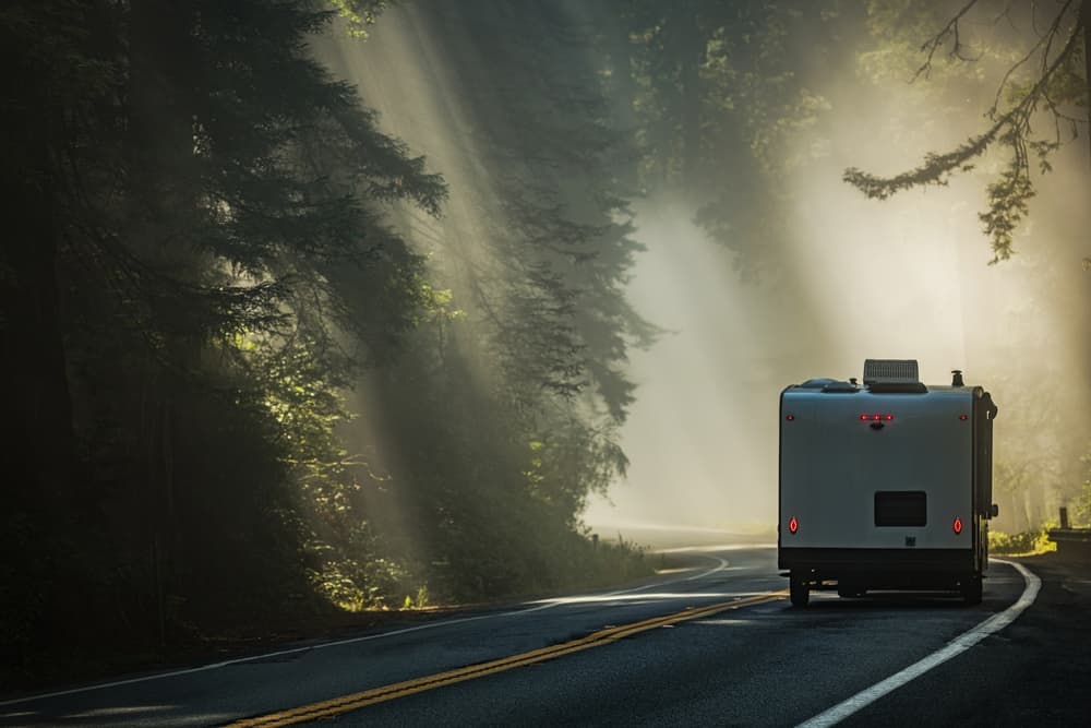 camper being towed on foggy road