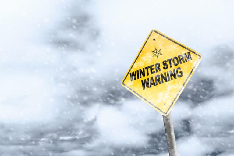 winter storm warning sign during a blizzard