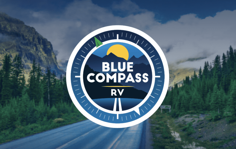 blue compass rv logo on scenic backdrop
