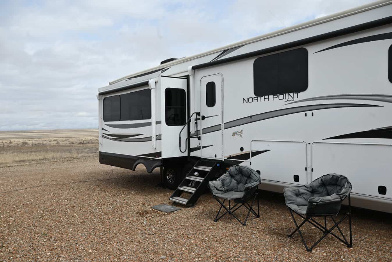 RV campsite setup, feature image for RVing vs Airbnb