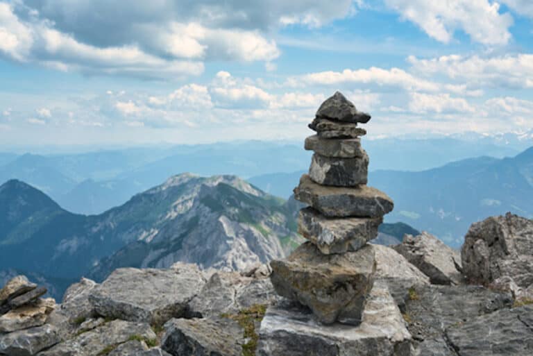 a stack of rocks on a mountain peak