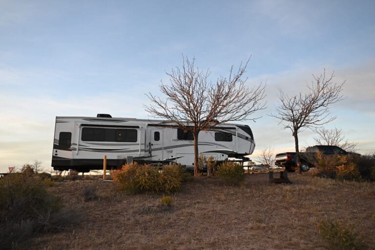 RV trailer campsite setup, feature image for RV loan refinancing: lower RV monthly payment