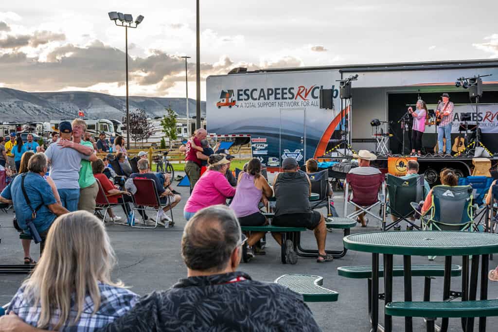An Escapees RV Club event features a crowd watching the Status Crowes.