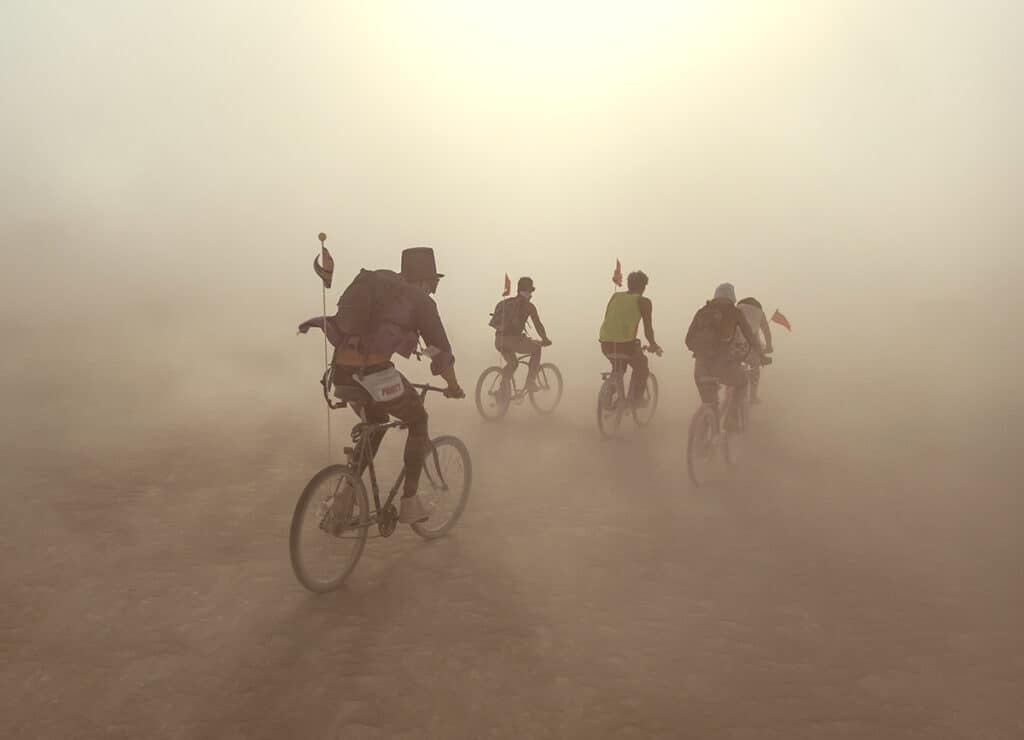 People on bikes in a dust storm