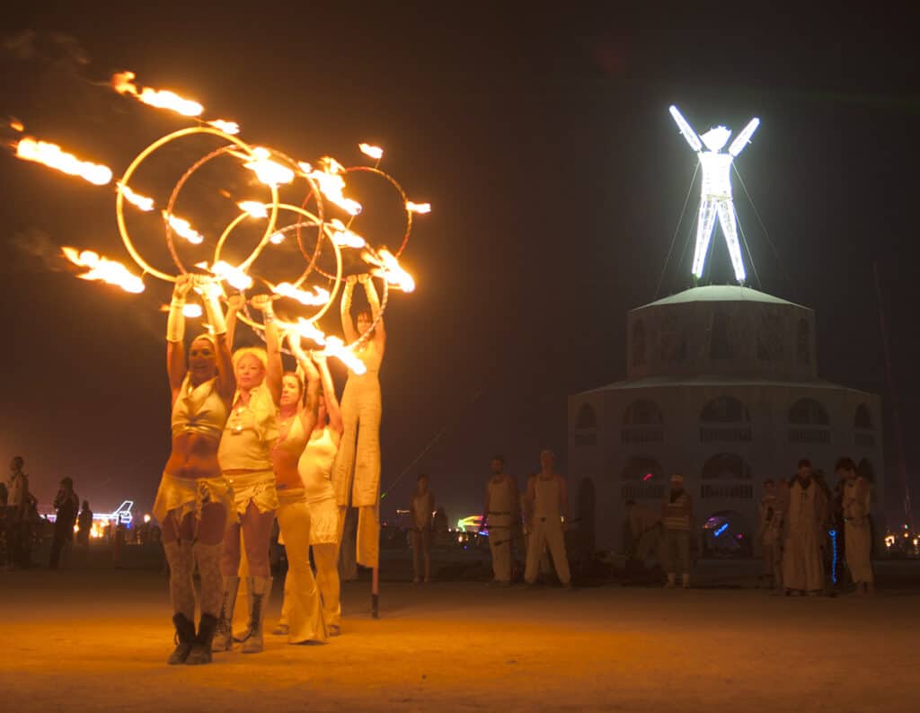 Burning Man man with fire dancers